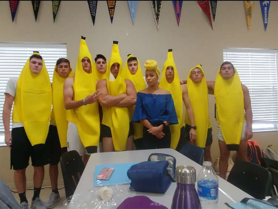 The Chiquita Banana is surrounded by seniors dressed up as bananas. 