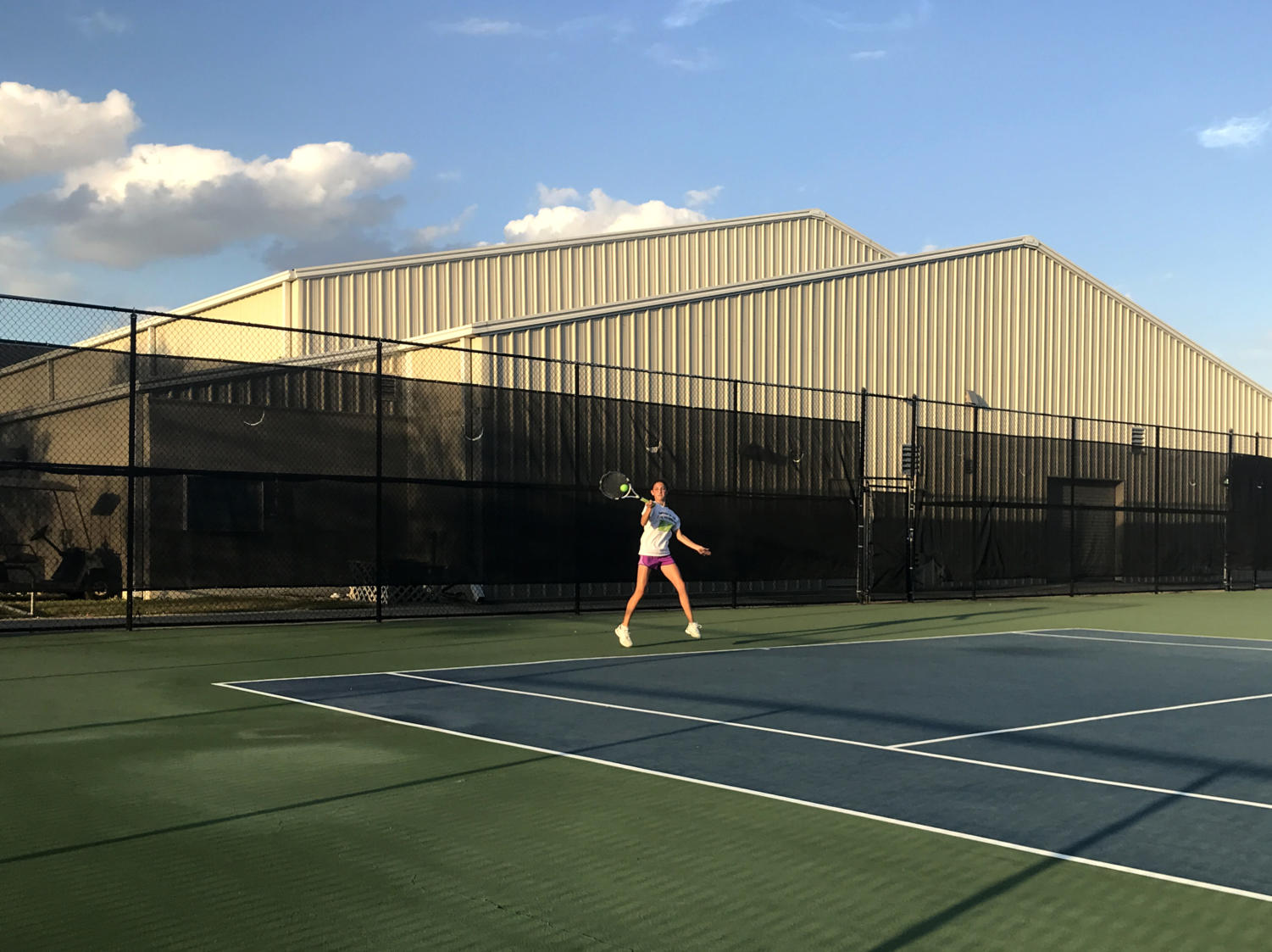 Seventh grader, Carly McNatt, practices skills at tennis practice after school.