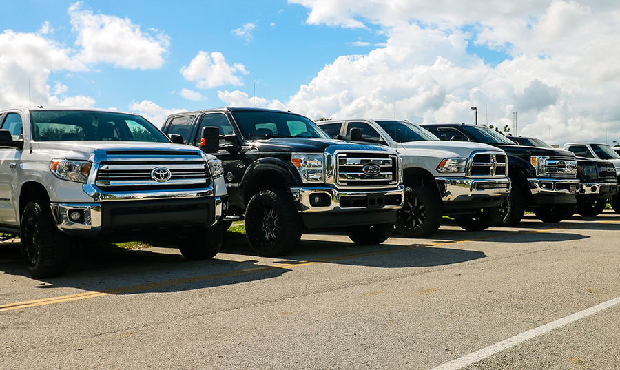 The large trucks some students drive stand out in the HT parking lot.