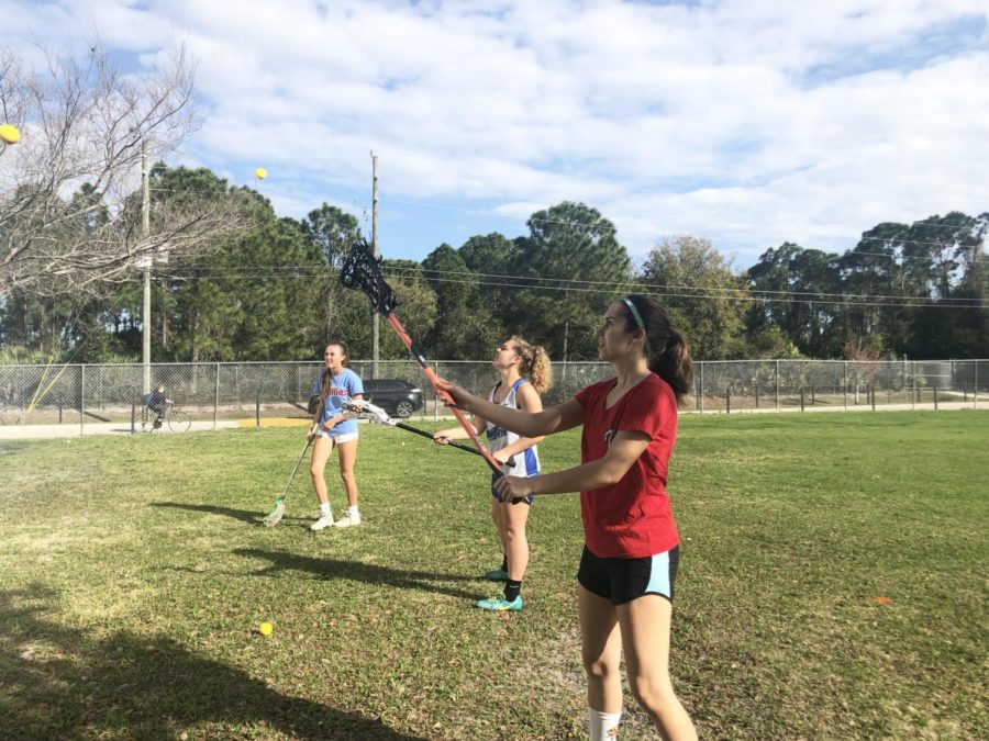 Girls lacrosse players practice ahead of their season. 