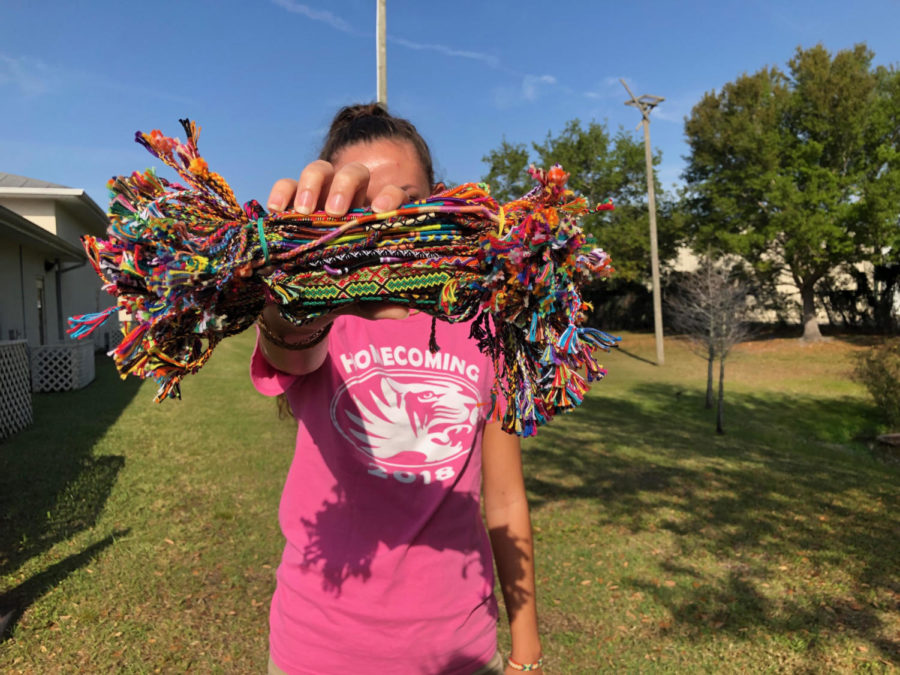 Sofia Obermaier holding some of the bracelets she is selling.