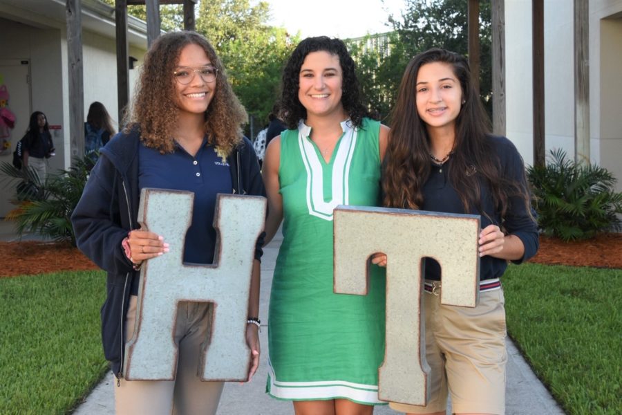 Mrs. Pedicini celebrates the first day of school with students Sophia Panarese (R) and Cassie Martin (L). This is Mrs. Pedicinis seventh year at Holy Trinity, but first working in administration rather than teaching.
