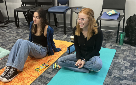 Seniors Sophia Panarese and Savannah Harris relax on their mats after guided breathing exercises.

