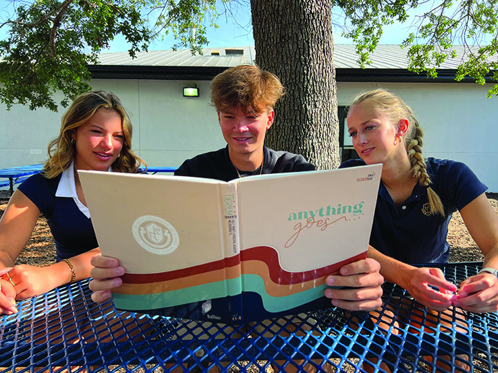 Left: Seniors Kendall Johnson, Canon Hopper, and Kaileigh Smith enjoy looking back at memories captured in the yearbook.