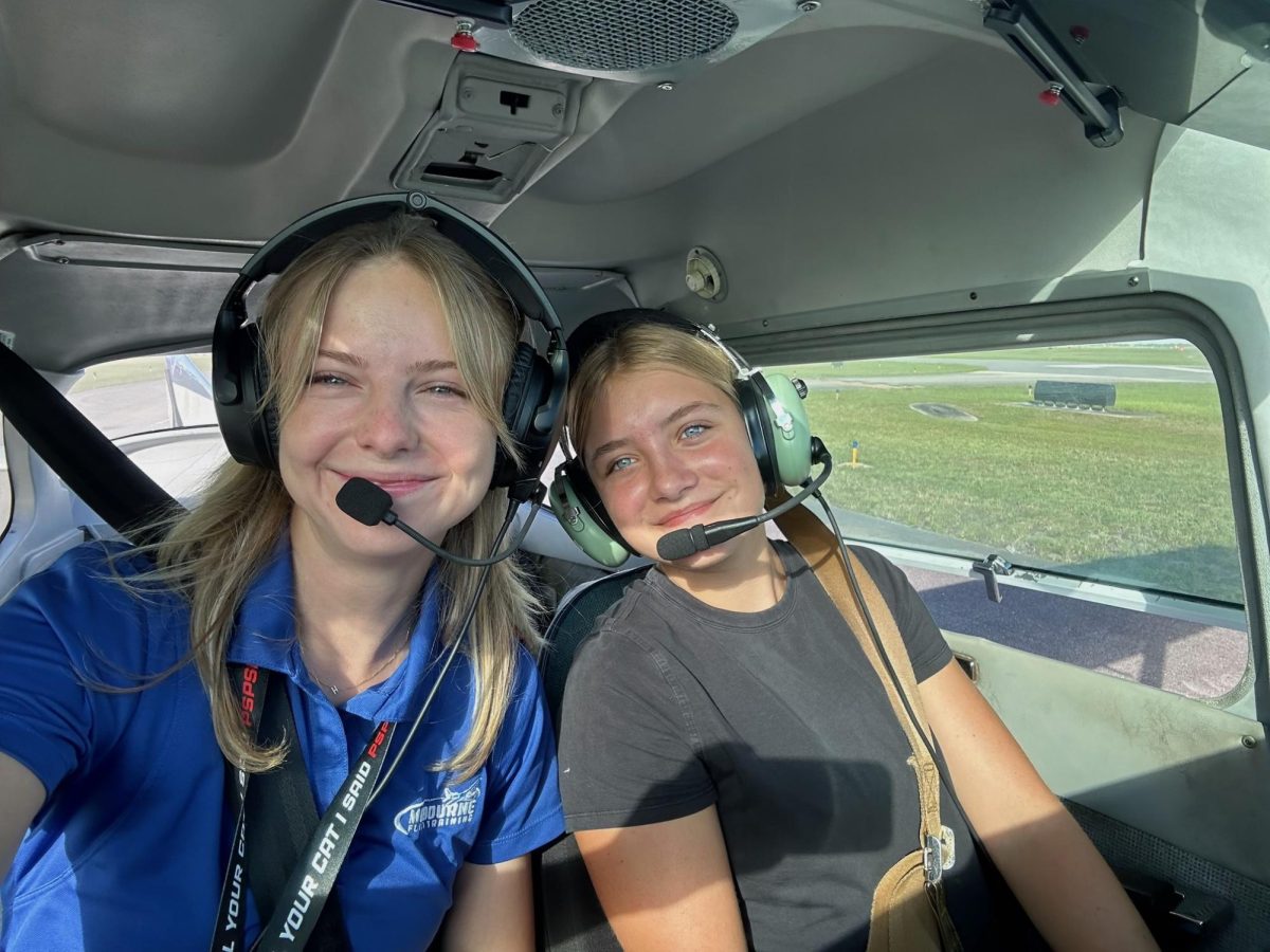 Junior Delaney Schmoll, right, prepares to take off with her flight instructor.