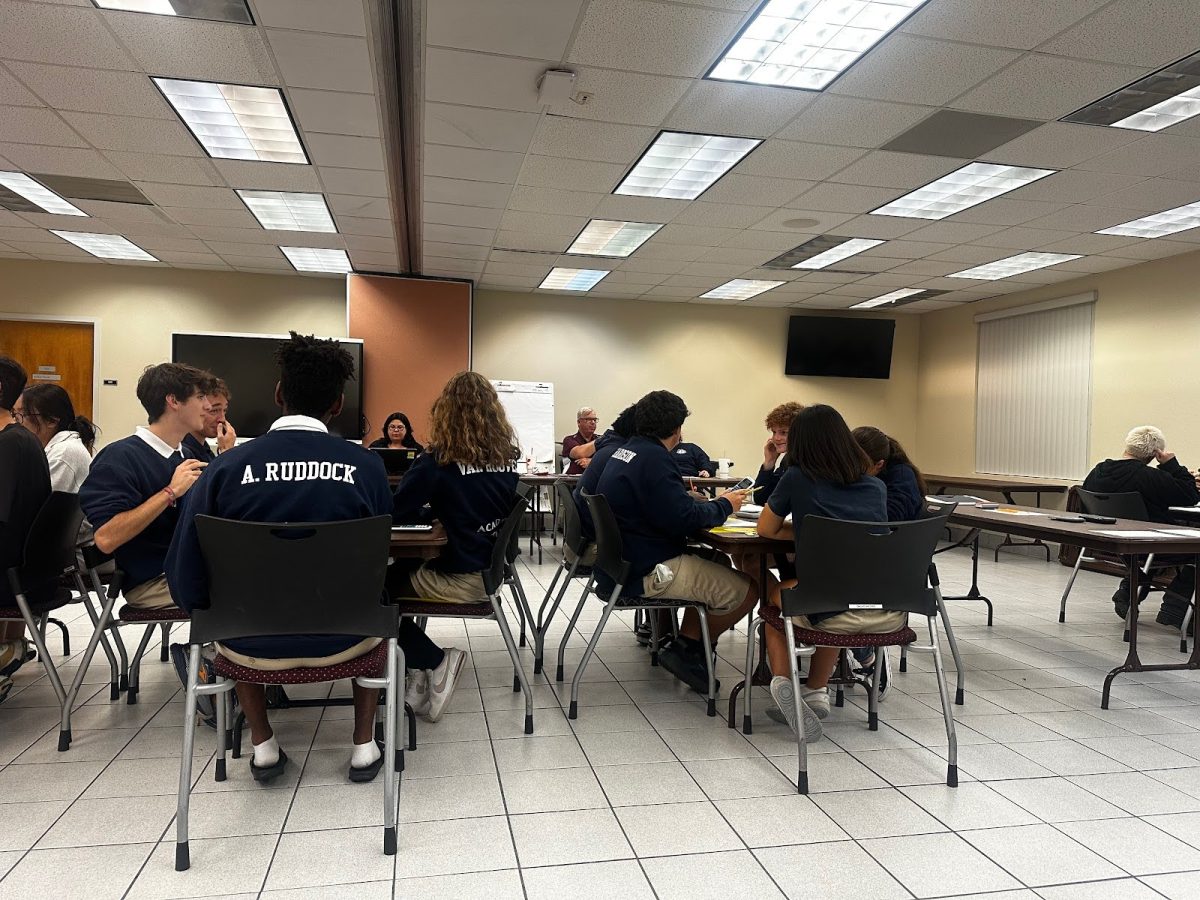 Holy Trinity’s Academic Team members work together to answer a team question. Team One on the left, and Team Two on the right.