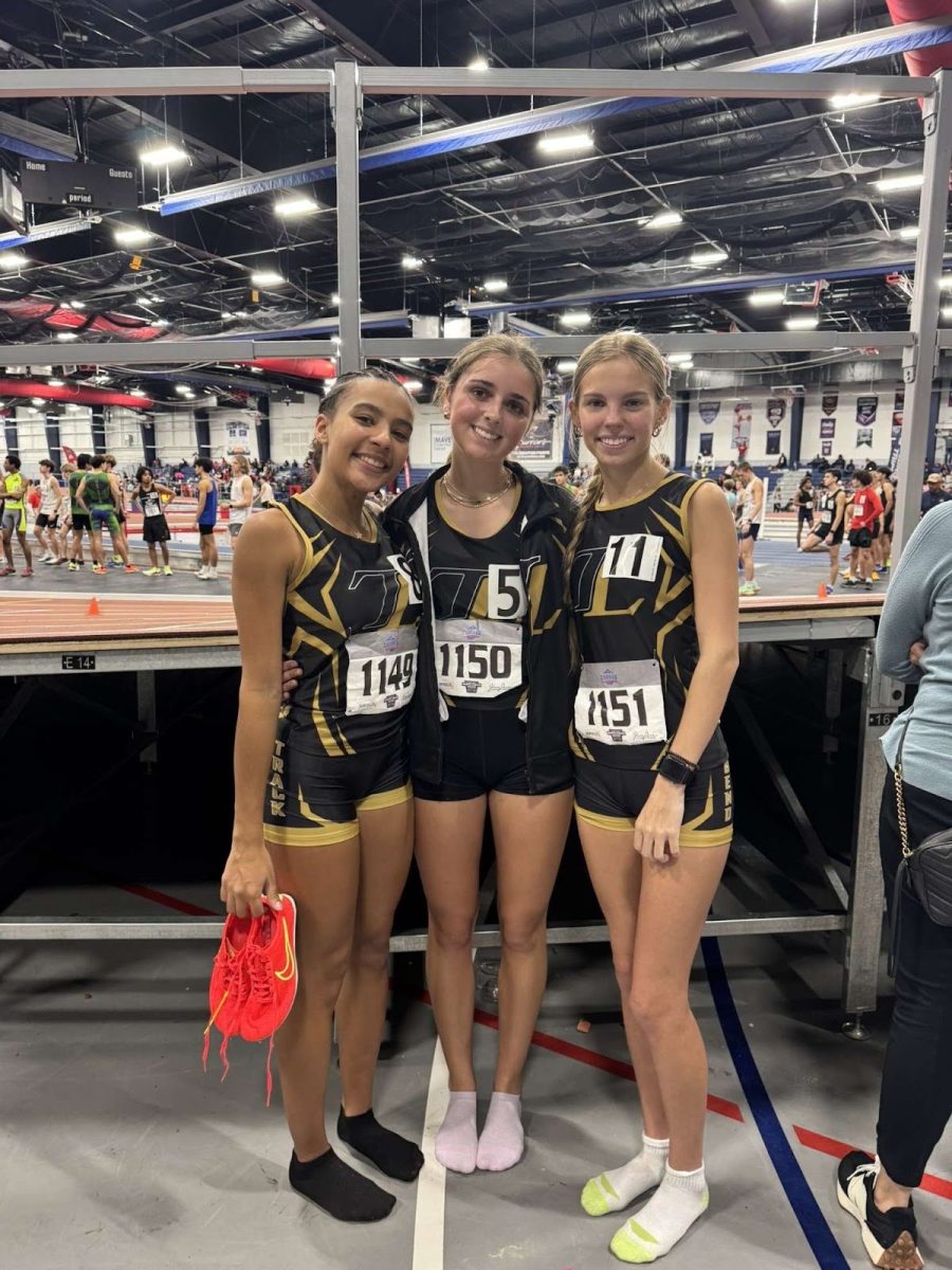 Senior Aniyah Francis, sophomore Frances Hale, and junior Grace Mooney posing before taking the track for the first meet of the season.