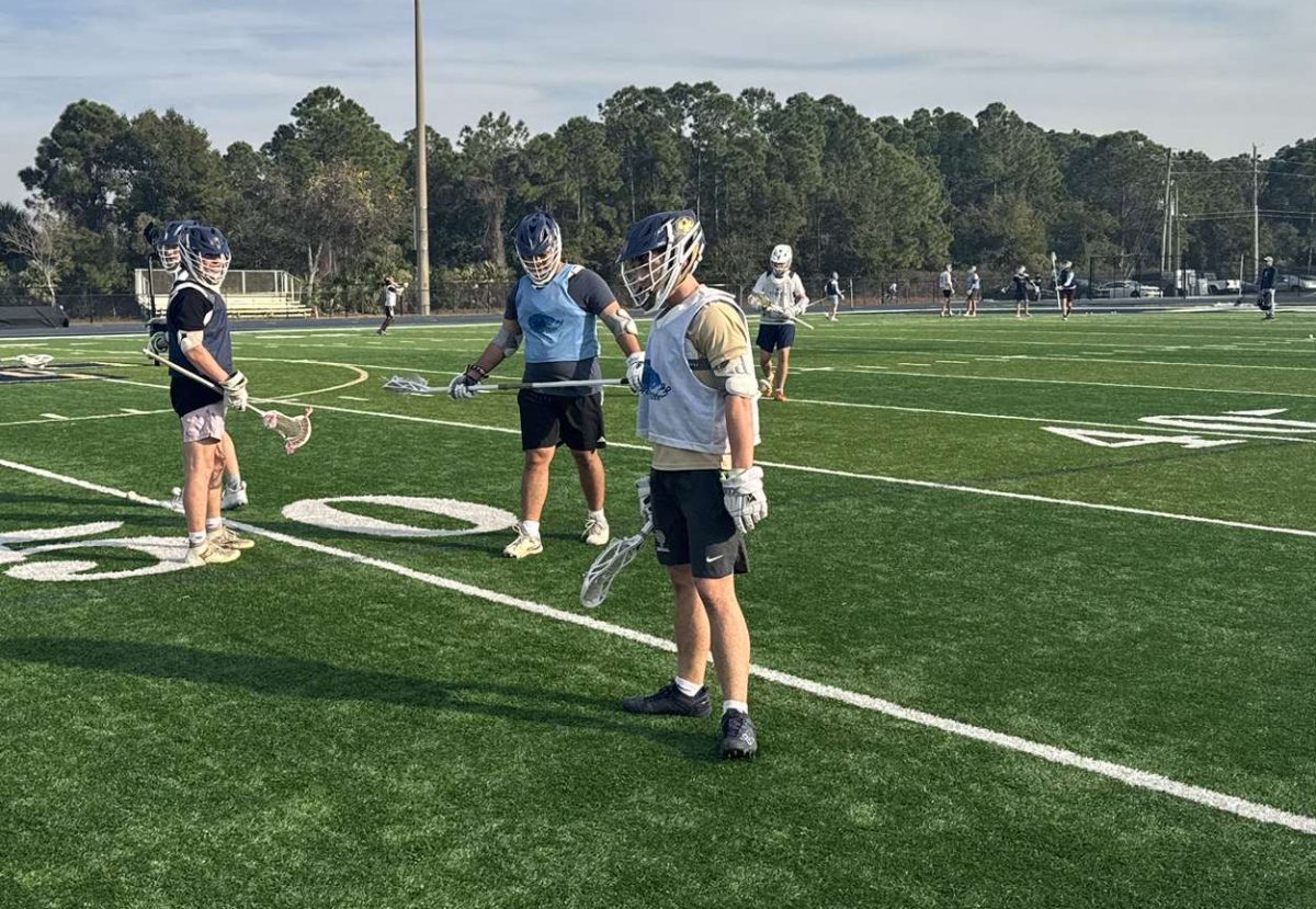 Sophomores Drew Zabinski, Nick Rahmes, and senior Sawyer Jacobs warming up before working hard at another practice.