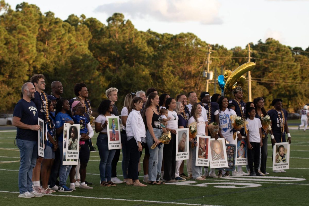 The football players, cheerleaders, and pep band members celebrated their senior night at the game against Oxford Academy.