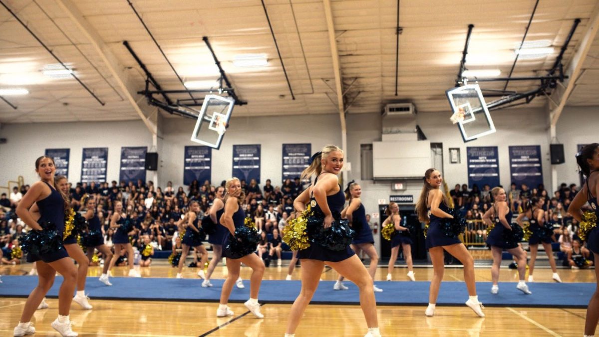The varsity cheer team kicks off the pep rally before the 'Welcome to the Jungle' themed home game.