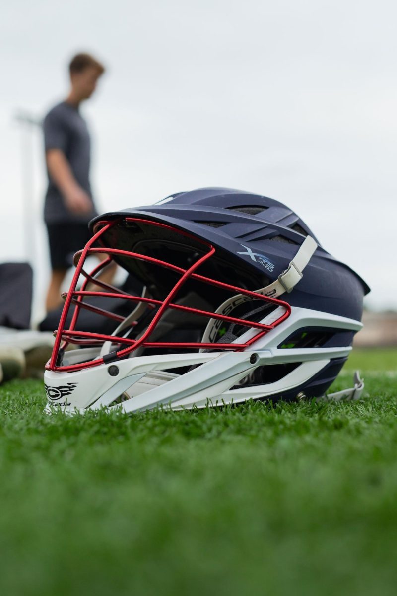 HT Alumni and FAU lacrosse player Myles Smith gets his helmet ready for his workout with current HT lacrosse players at Kelly Stadium on December 9, 2025. 