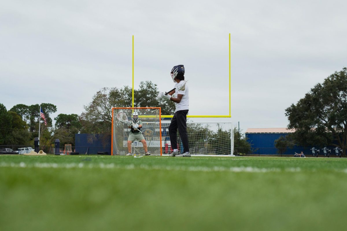 Myles Smith begins his workout by shooting on HT’s goalie Joe Wallace at Kelly Stadium on November 9, 2025.