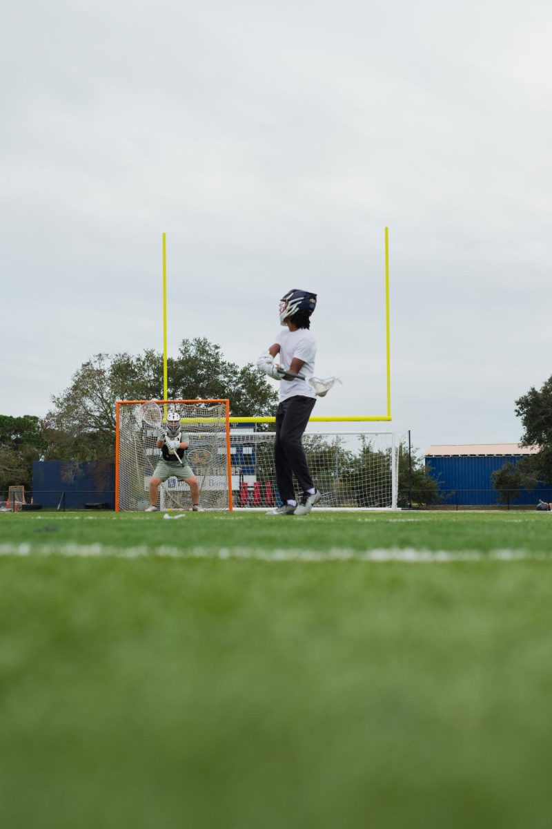 Myles Smith takes some warm-up shots on the varsity goalie Joe Wallace at Kelly Stadium on November 9, 2025.